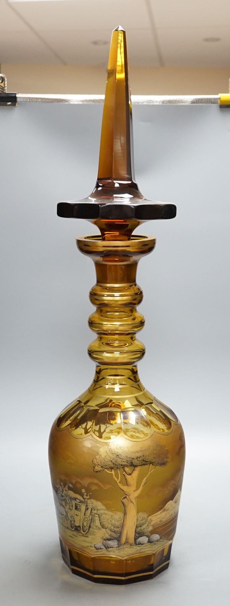 A large amber glass decanter and stopper, 74cm